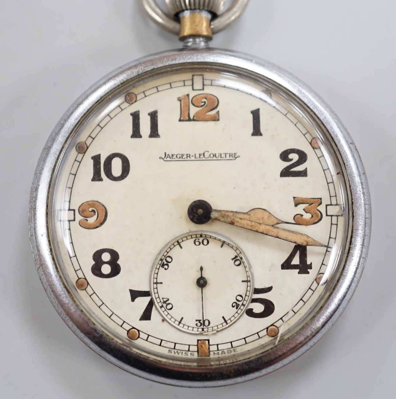 A nickel cased Jaeger LeCoultre military issue pocket watch, with Arabic dial and subsidiary seconds, the case back numbered G.S.T..P below broad arrow F034915.